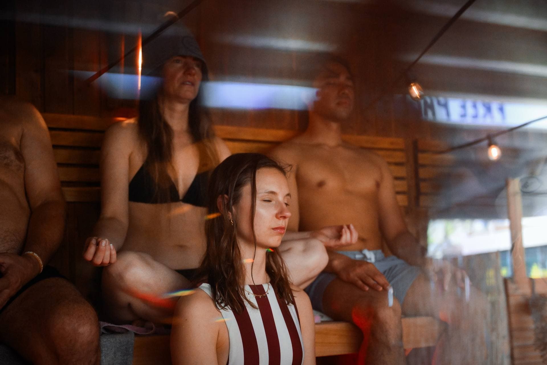 Guests resting with closed eyes in the steam