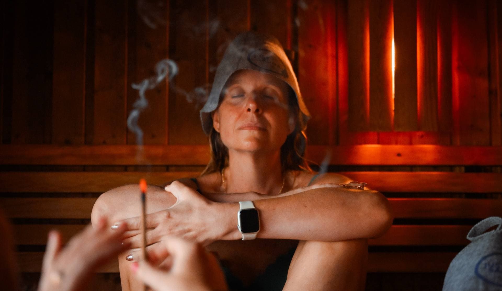 A guest with closed eyes as herbal smoke rises
