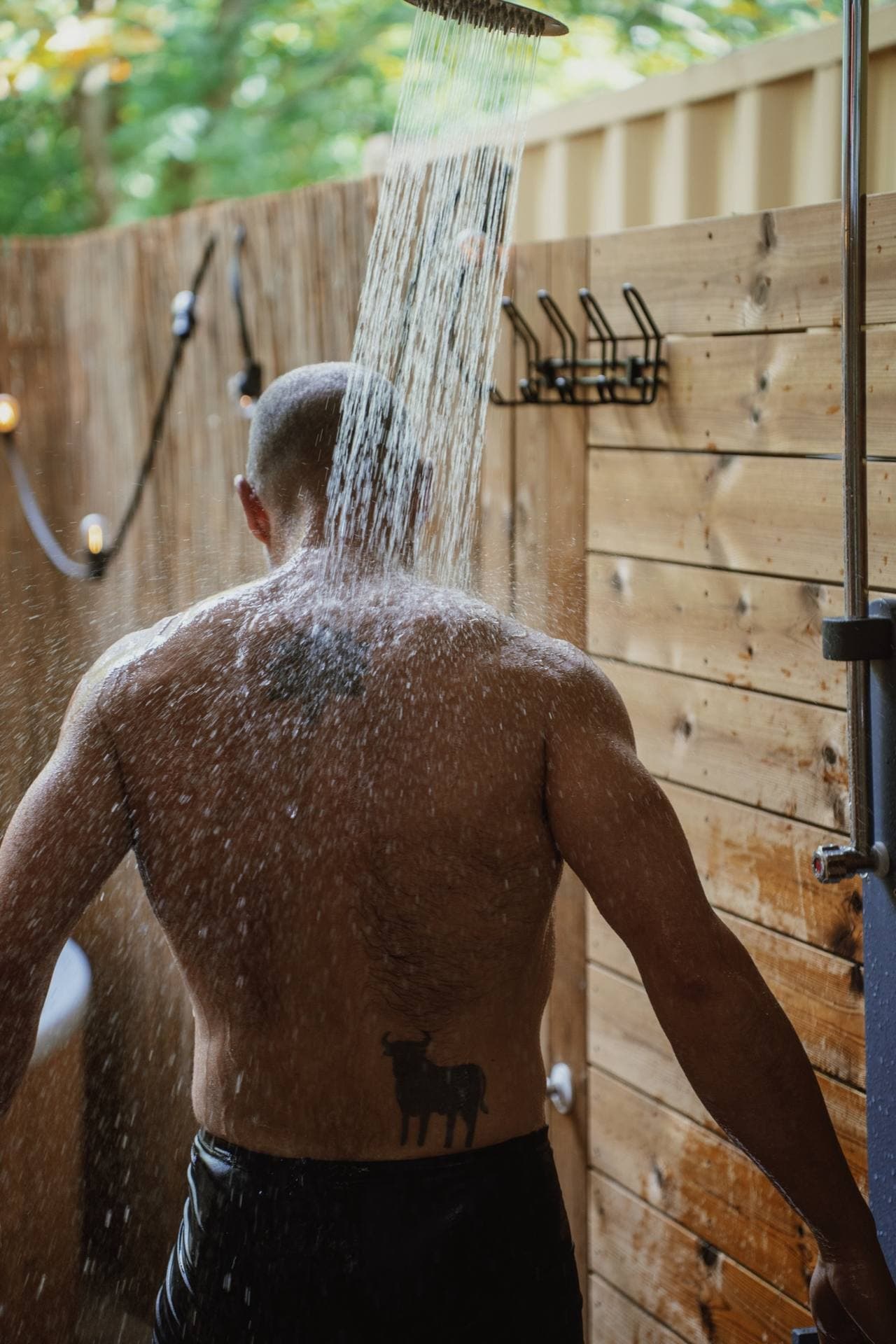 A guest under the outdoor shower