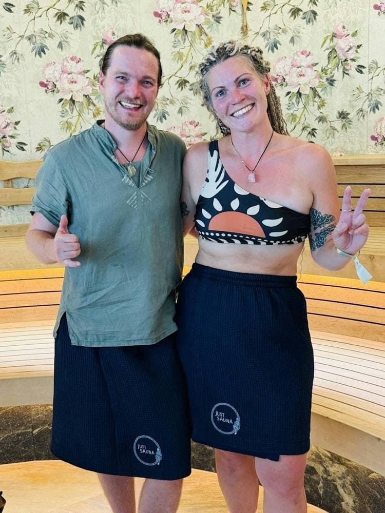 Two guests in navy sauna kilts