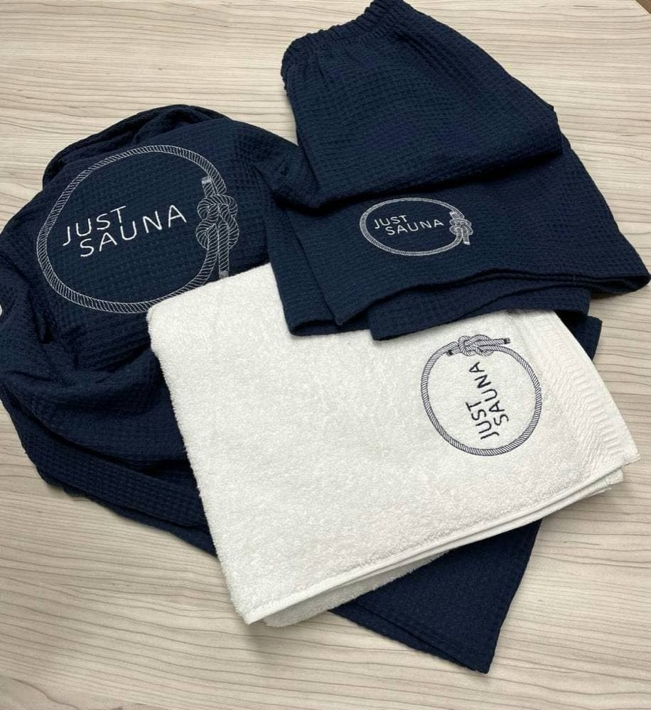 Swinging towels with the embroidered Just Sauna logo