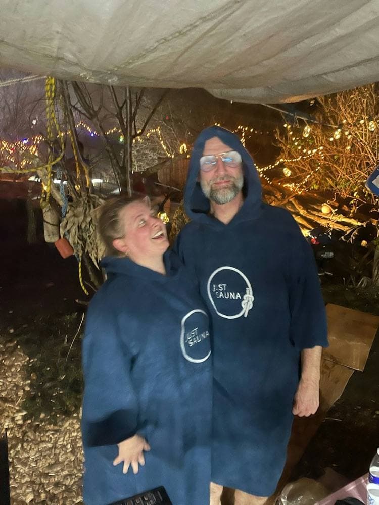 Two guests in navy towel ponchos