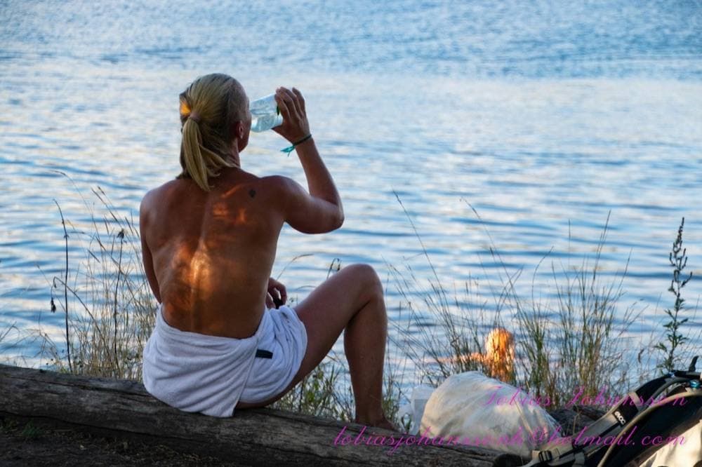 A guest in a towel by the water